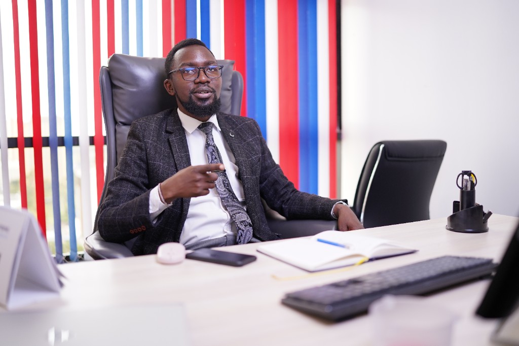AfriPixel director speaking from a modern office desk